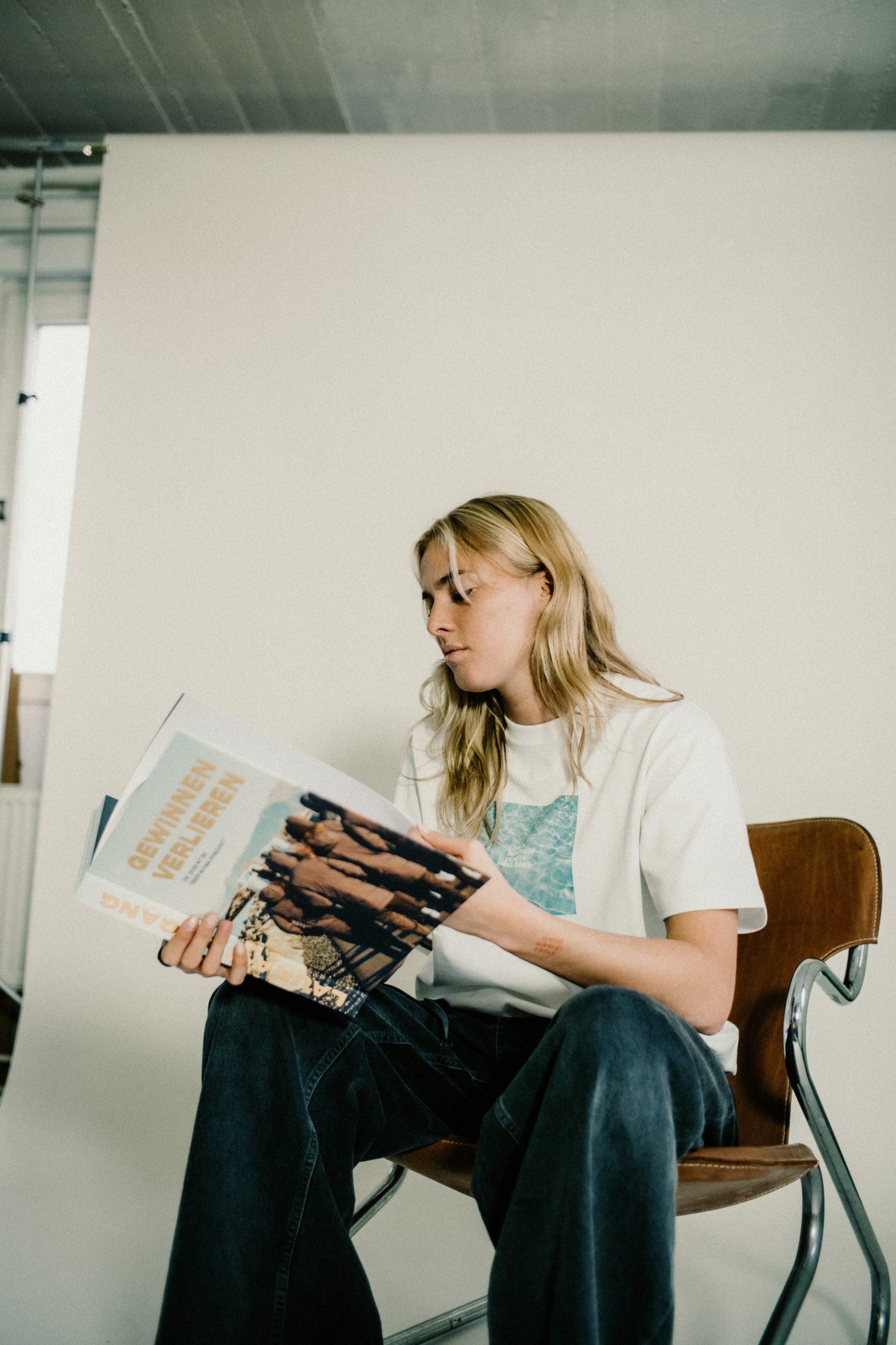 Laura Freigang looking at a photo book she produced